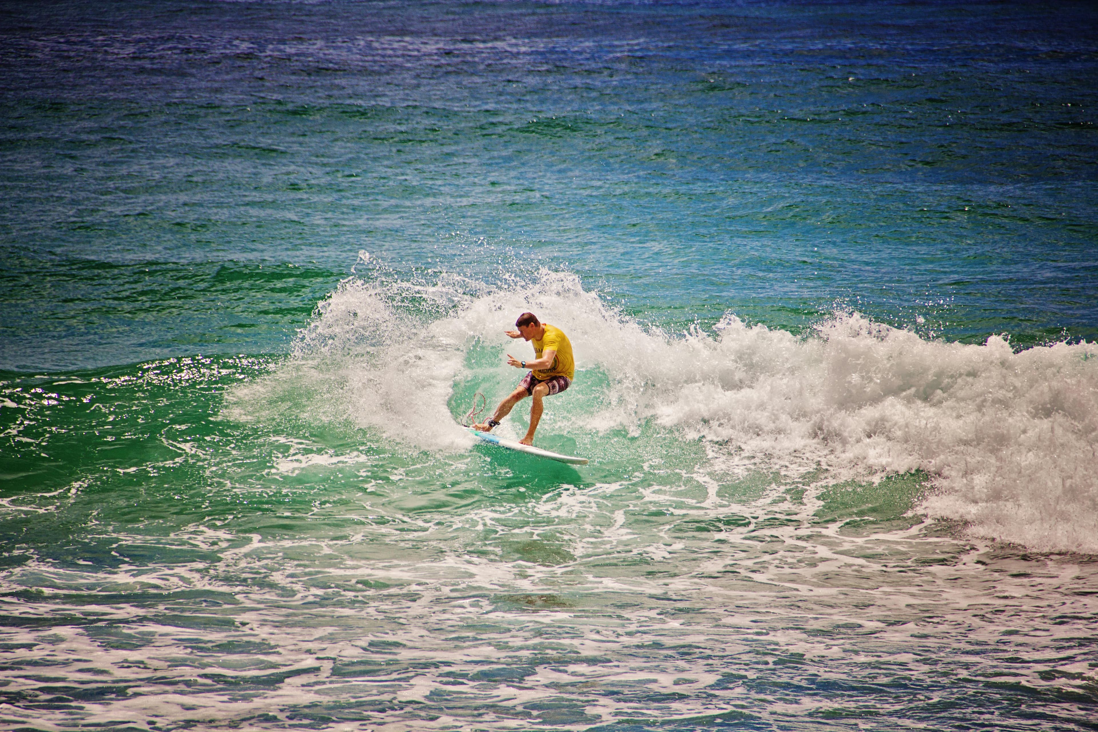Surfer riding a wave, the world StrictlySurf serves, captured rather than the marketplace UI itself