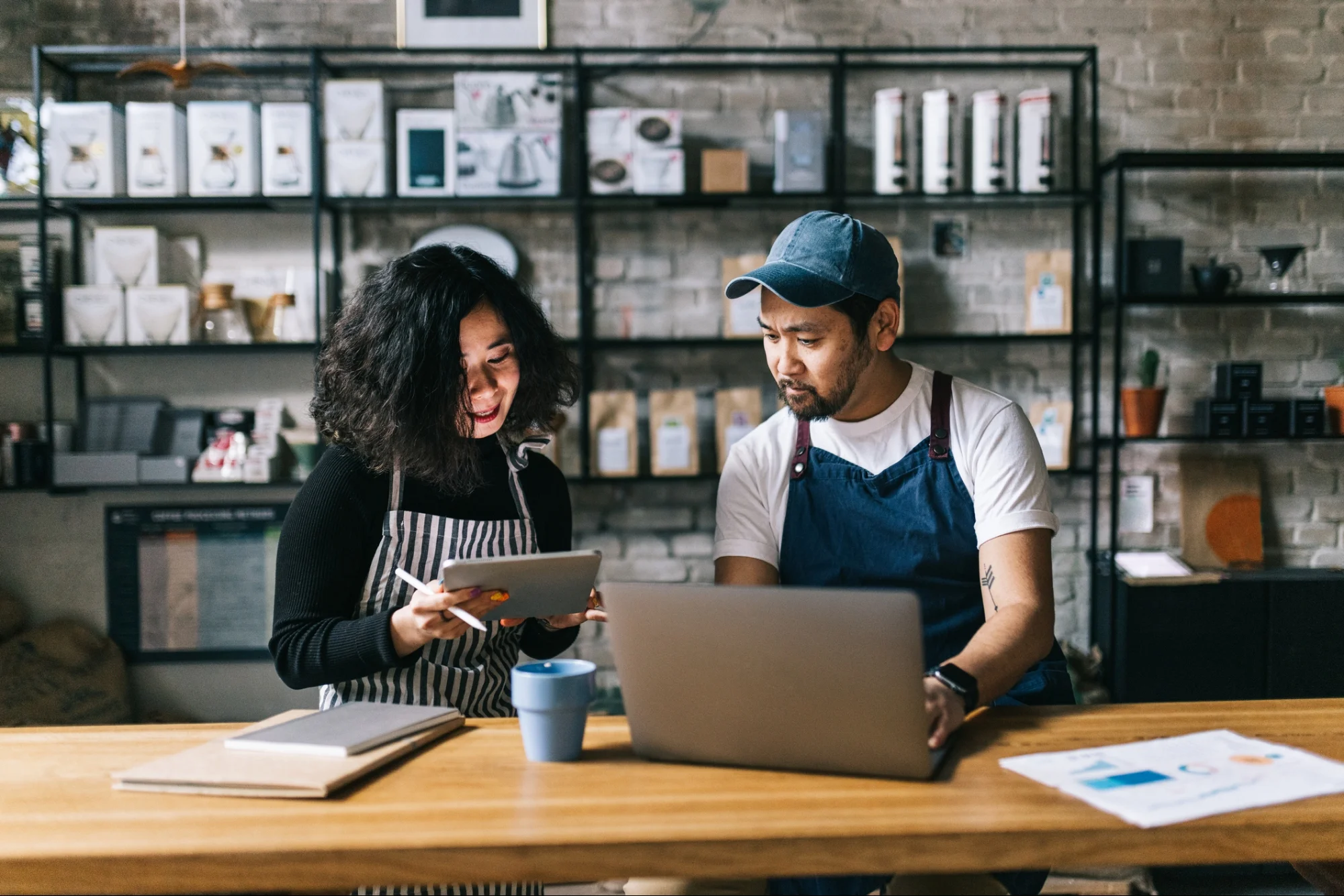 Small business owners reviewing their monthly digital maintenance plan on a tablet
